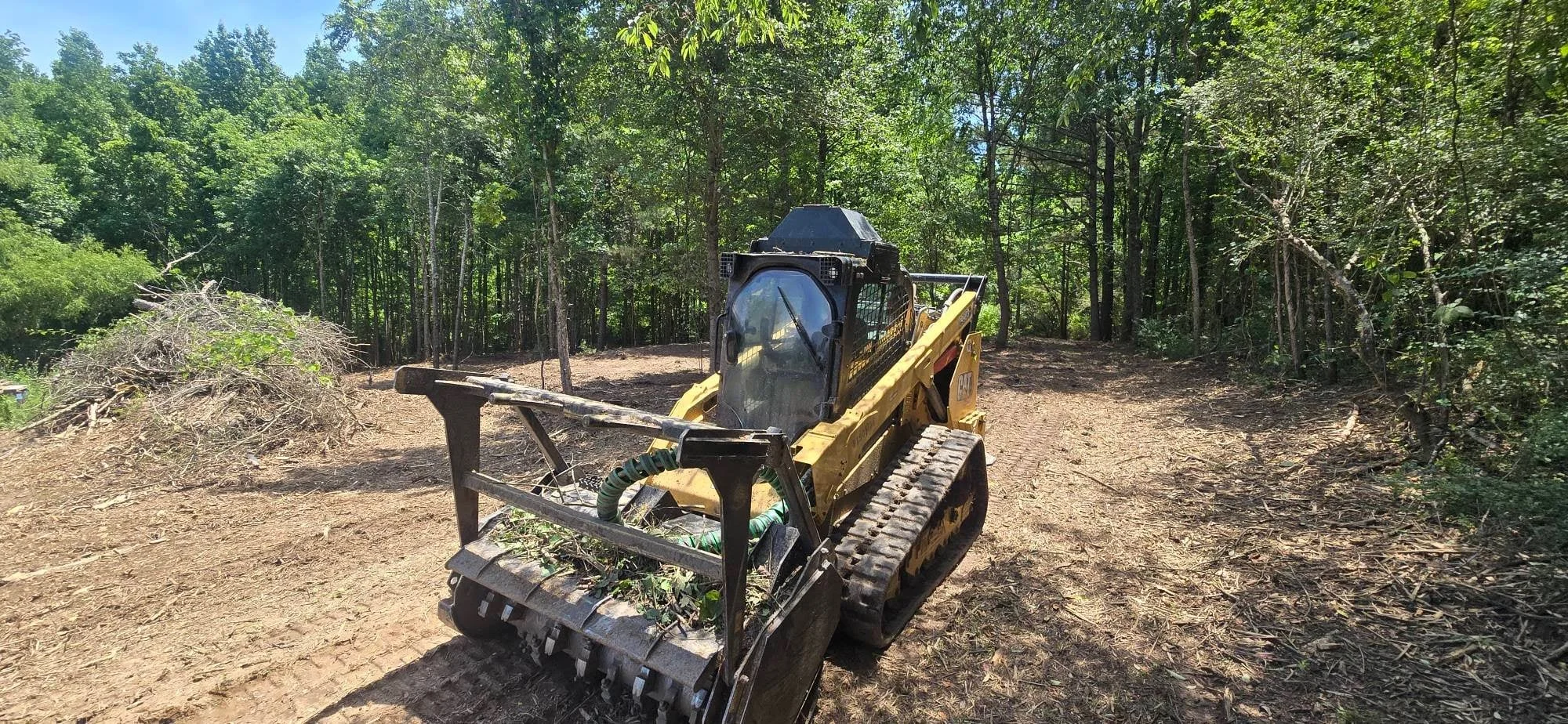 Construction crew and heavy equipment on a cleared land site, ready for the next phase of work.