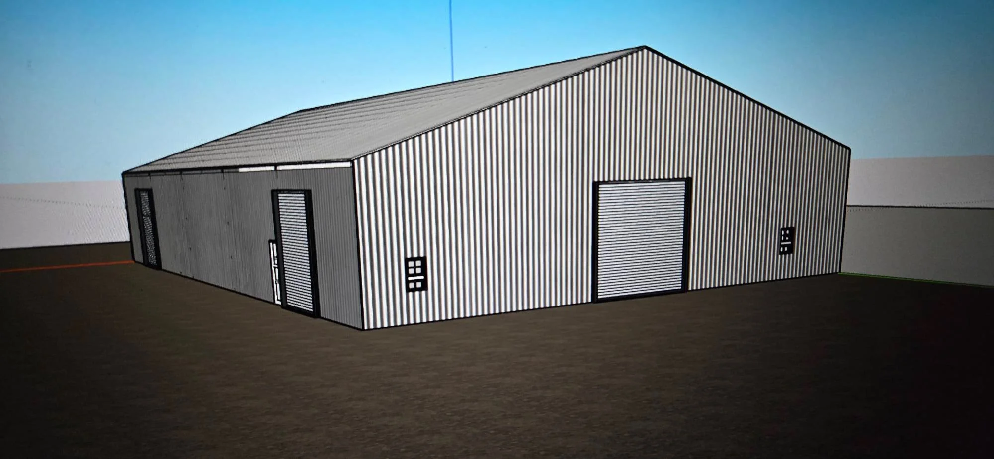 Metal frame agricultural building with corrugated steel siding, gable roof, and louvered ventilation panels