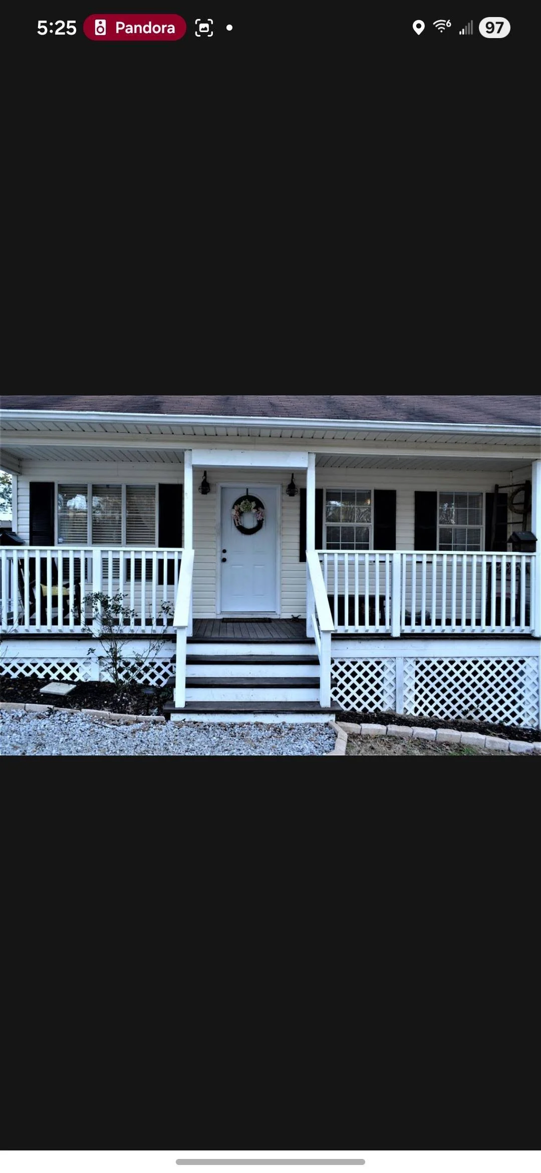 White vinyl railing and black composite deck with lattice skirting on residential front porch