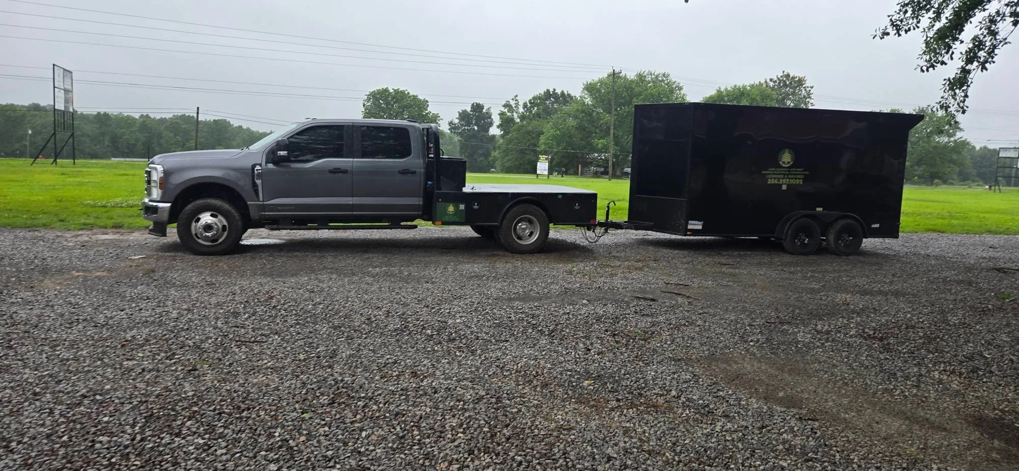 Gravel driveway with compacted stone surface, truck and trailer parked on completed drive